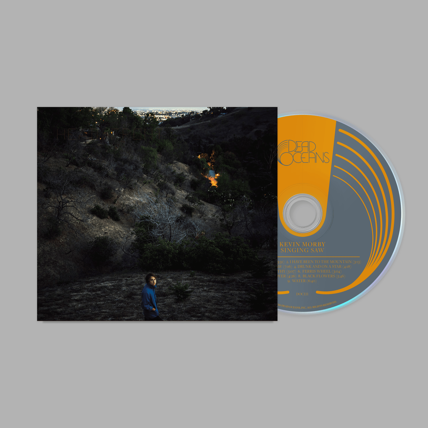 Singing Saw CD with Kevin Morby cover art showing a person in a dark, wooded hillside at dusk