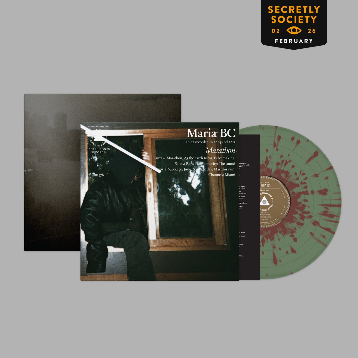 Marathon vinyl record with splattered red and green design alongside album cover featuring dark moody photograph.